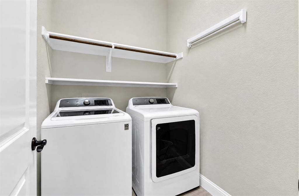 12038 Big Springs Drive, Frisco, TX 75035 Photo digitally enhanced by AI. Built-in overhead shelving maximizes vertical space to keep essentials neatly organized within arms reach. It turns everyday chores into a smooth, effortless routine.