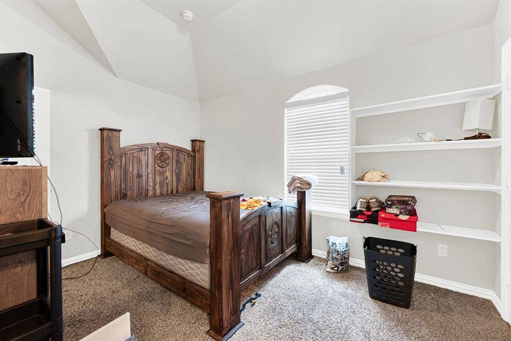 12038 Big Springs Drive, Frisco, TX 75035 Built-in shelving recessed into the wall provides smart storage while preserving open floor space under the angled ceiling. Imagine setting up a cozy guest sanctuary where visitors can unpack and feel right at home.