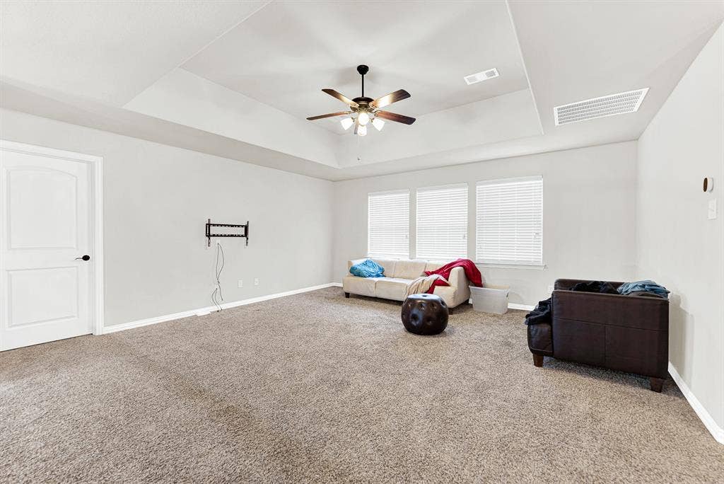 12038 Big Springs Drive, Frisco, TX 75035 A recessed tray ceiling with a central fan anchors this expansive game room layout. Picture afternoon video game marathons or casual hangout sessions with plenty of room to stretch out.