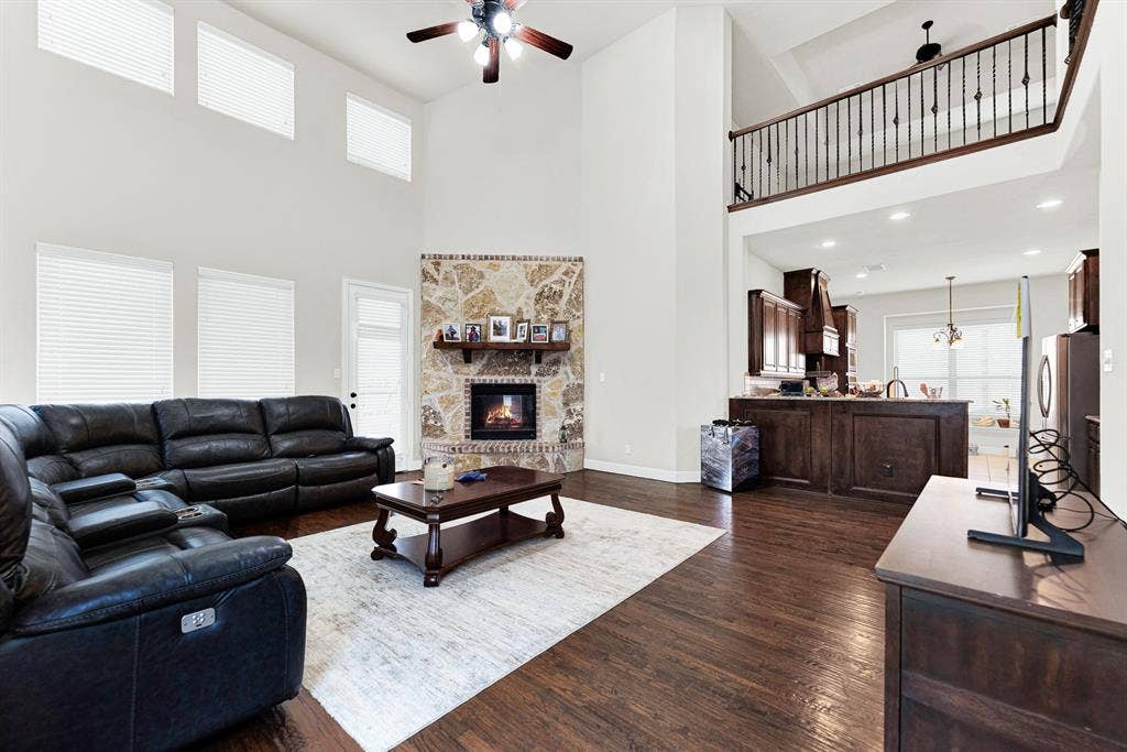 12038 Big Springs Drive, Frisco, TX 75035 An upper-level wrought-iron overlook frames the room, connecting the open living area seamlessly to the kitchen space below. It is the perfect setup for throwing open the doors and hosting easy weekend get-togethers with friends