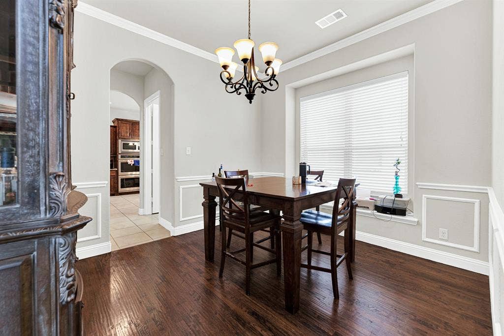 12038 Big Springs Drive, Frisco, TX 75035 A grand arched opening provides a clear visual connection into the heart of the home, drawing you towards the adjacent living spaces. Imagine casual family game nights at the table, just steps away from the action in the kitchen and great room.