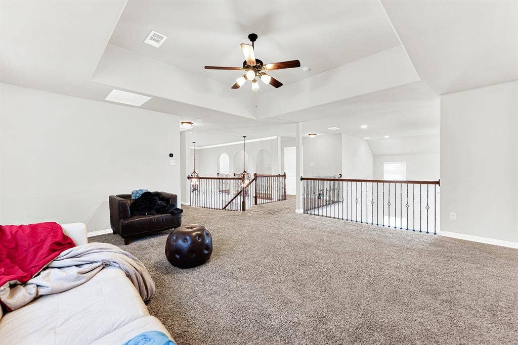 12038 Big Springs Drive, Frisco, TX 75035 Open wrought-iron railings frame the loft, offering sweeping views down into the entry and main living areas below. It is an ideal setup for keeping the upstairs lively while staying seamlessly connected to the rest of the home.