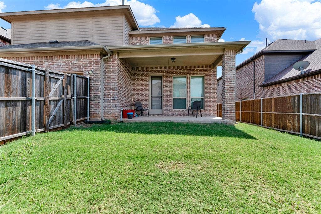 12038 Big Springs Drive, Frisco, TX 75035 Tall brick pillars frame this sheltered outdoor seating area overlooking the entire backyard. It is an ideal setting for grilling evening meals or unwinding under the stars after work.