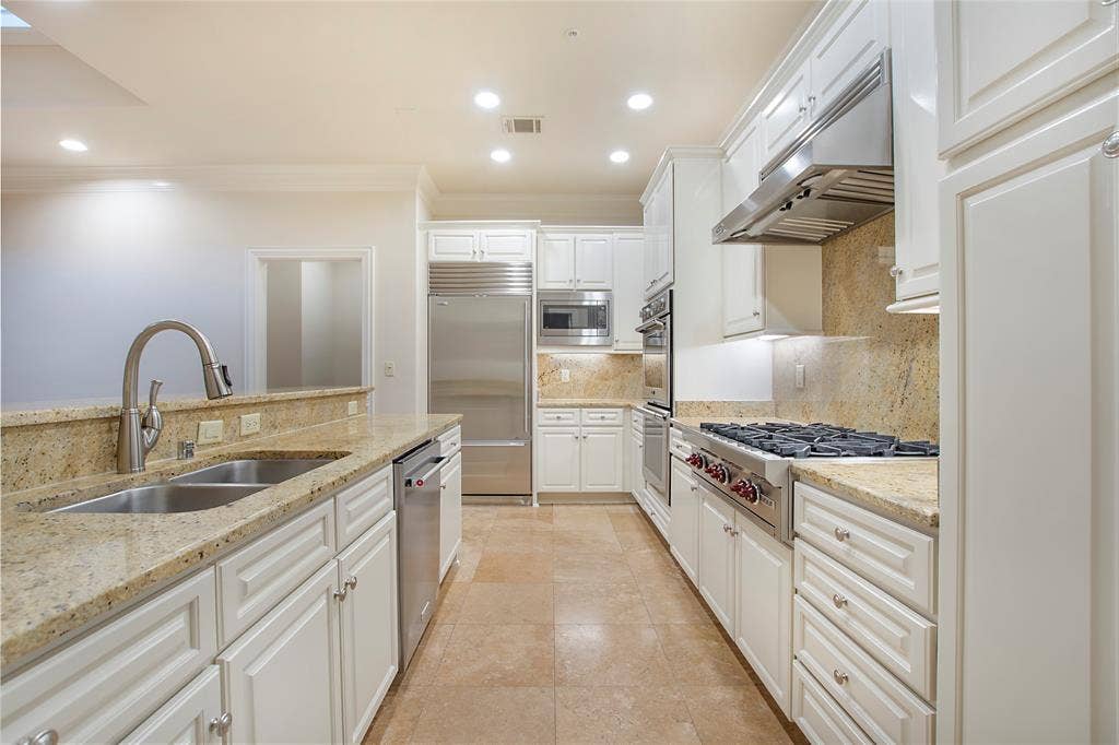 6535 Bandera Avenue, #1B, Dallas, TX 75225 Kitchen with tasteful backsplash, light stone countertops, sink, white cabinetry, and built in appliances