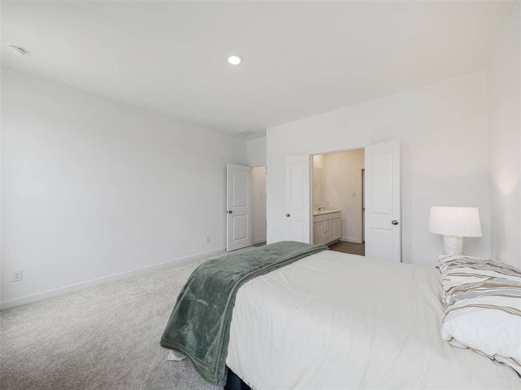 2517 Greenbelt Road, Celina, TX 75009 Recessed ceiling lighting, light gray wall-to-wall carpeting, white interior doors, and a double-door entryway to a bathroom with a vanity