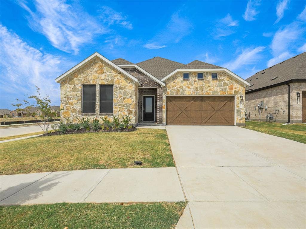 2517 Greenbelt Road, Celina, TX 75009 Stone and brick facade with a wood-finish garage door
