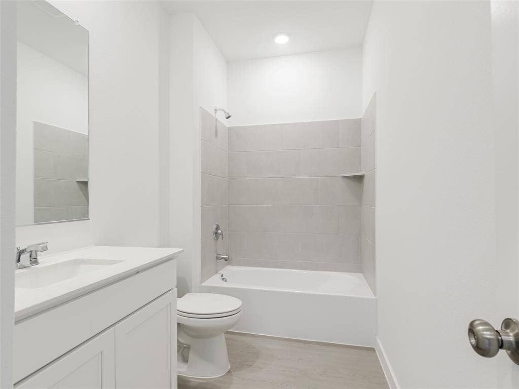 2517 Greenbelt Road, Celina, TX 75009 Tub-shower combination with light gray subway tile surround and integrated shelf