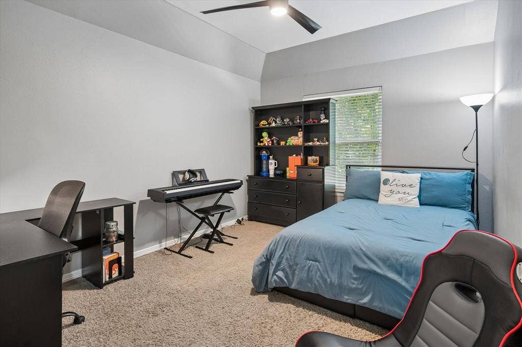 7525 Cedar Elm Drive, Irving, TX 75063 Vaulted ceiling with a ceiling fan, window with blinds, and neutral carpeting