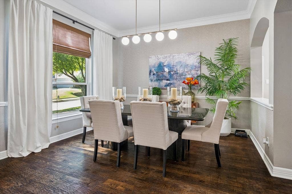 7525 Cedar Elm Drive, Irving, TX 75063 Wood-finish flooring throughout, complemented by crown molding and wainscoting