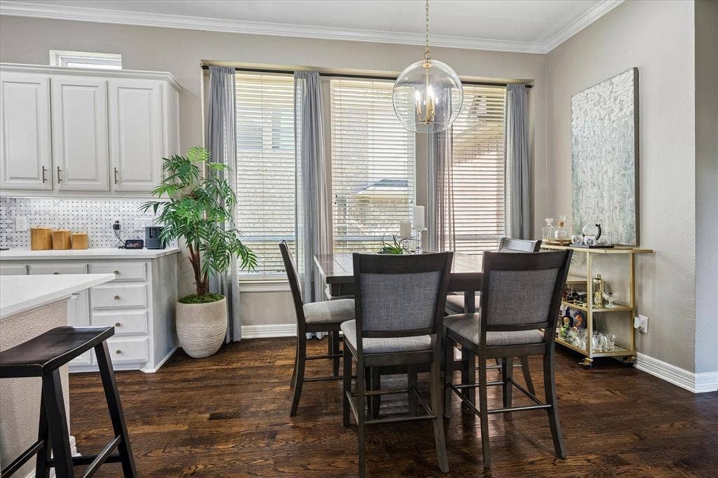 7525 Cedar Elm Drive, Irving, TX 75063 Hardwood flooring, white cabinetry, integrated lighting, large windows with blinds, and a contemporary spherical chandelier