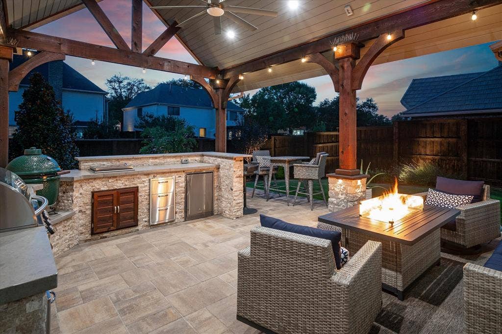 7525 Cedar Elm Drive, Irving, TX 75063 Covered outdoor patio with exposed beam ceiling, built-in outdoor kitchen, stone fire pit, and paver flooring