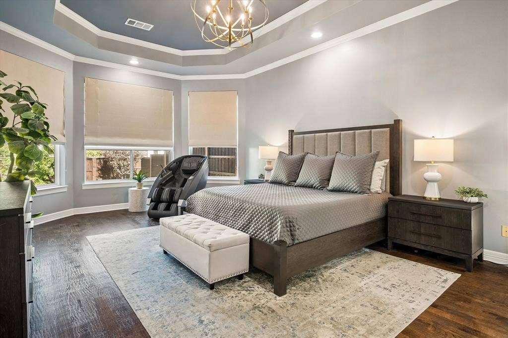 7525 Cedar Elm Drive, Irving, TX 75063 Tray ceiling with recessed lighting and a decorative chandelier, wood-finish flooring, and multiple windows with roller shades