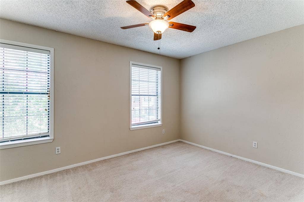 238 Samuel Boulevard, #1T, Coppell, TX 75019 Neutral wall tones, two windows with blinds, and a ceiling fan with integrated lighting