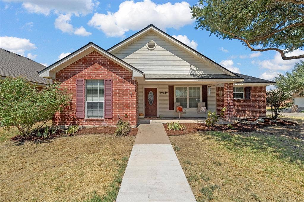 Brick and siding exterior with a covered front entry