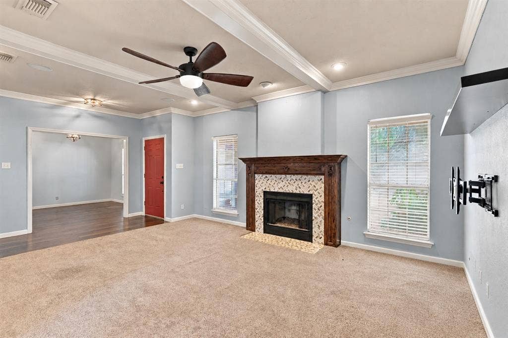 1309 Oxford Lane, Denton, TX 76209 Living space featuring a fireplace with a wood mantle and tile surround, recessed lighting, and a ceiling fan