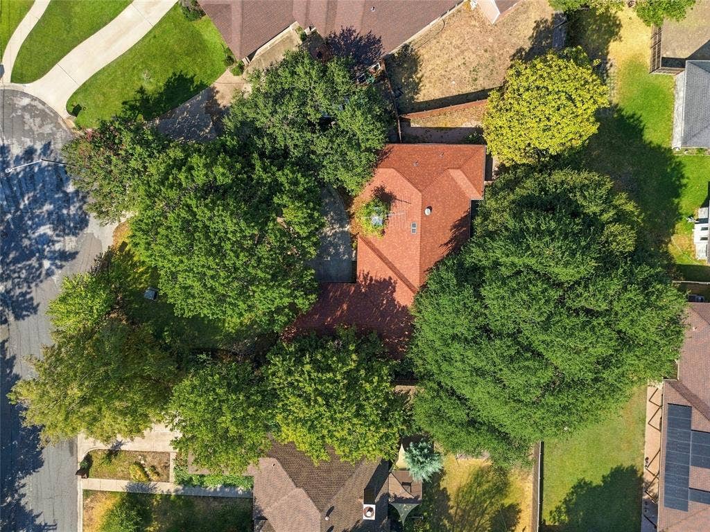 1309 Oxford Lane, Denton, TX 76209 Red-toned roof structure surrounded by mature trees