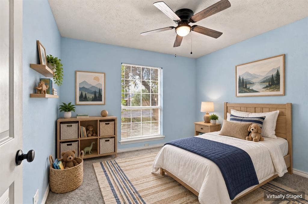 1309 Oxford Lane, Denton, TX 76209 Light blue painted walls, ceiling fan with integrated lighting, wood-frame window, and wood-finish door with black hardware