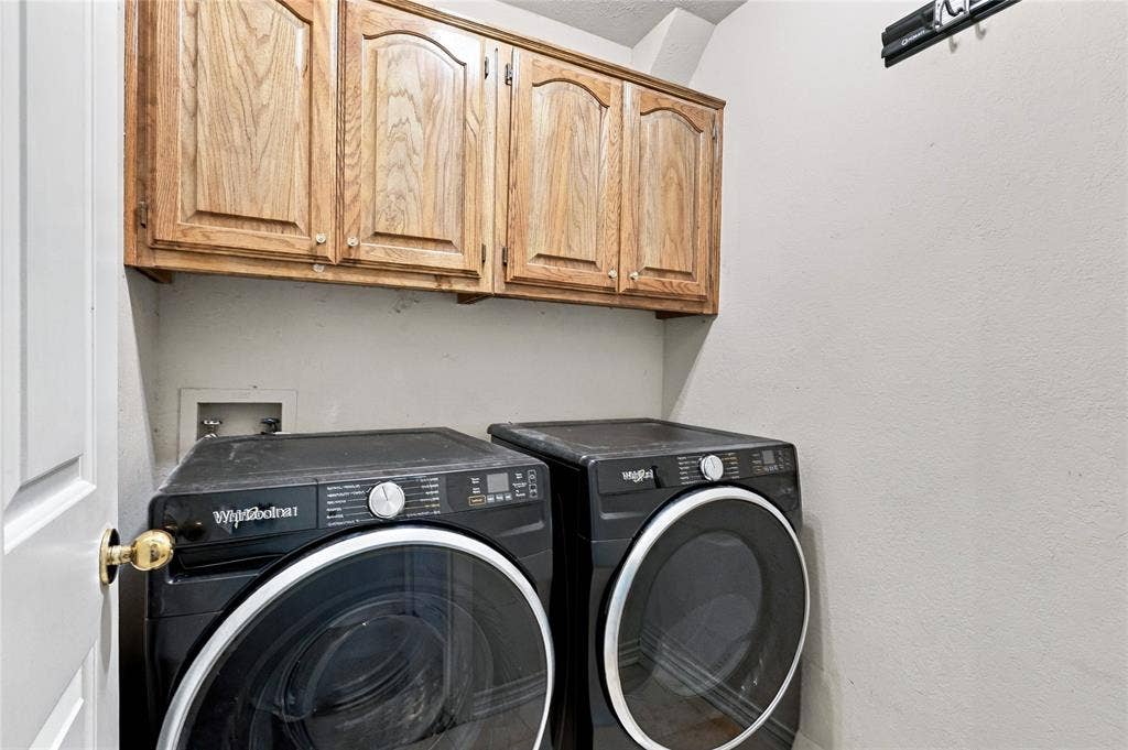 1309 Oxford Lane, Denton, TX 76209 Overhead wood cabinetry provides storage within this utility space