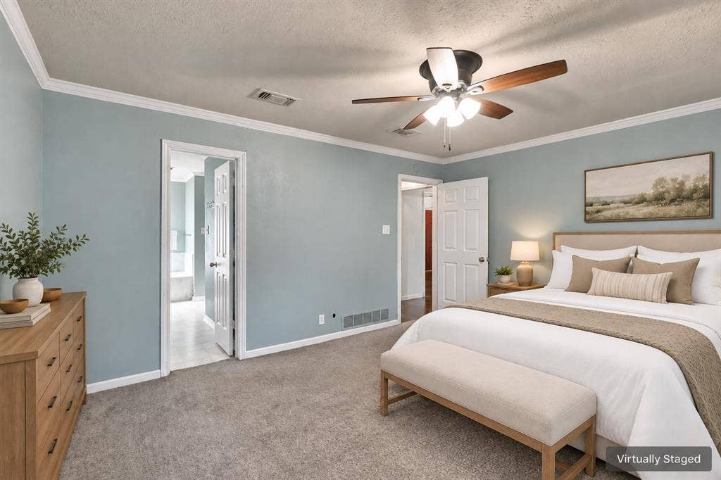 1309 Oxford Lane, Denton, TX 76209 Plush carpeting, crown molding, and a ceiling fan with integrated lighting