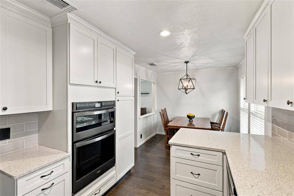 1309 Oxford Lane, Denton, TX 76209 White shaker-style cabinetry with dark hardware