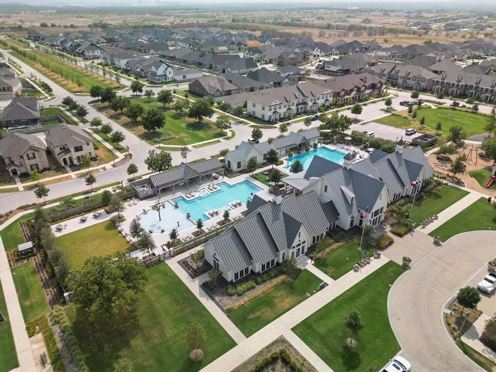2812 Dunbar Drive, Northlake, TX 76247 Community clubhouse with multiple swimming pools, extensive green spaces, and a playground structure