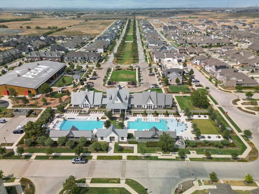2812 Dunbar Drive, Northlake, TX 76247 Expansive community featuring multiple residential structures, two large swimming pools, manicured green spaces, and a prominent community building