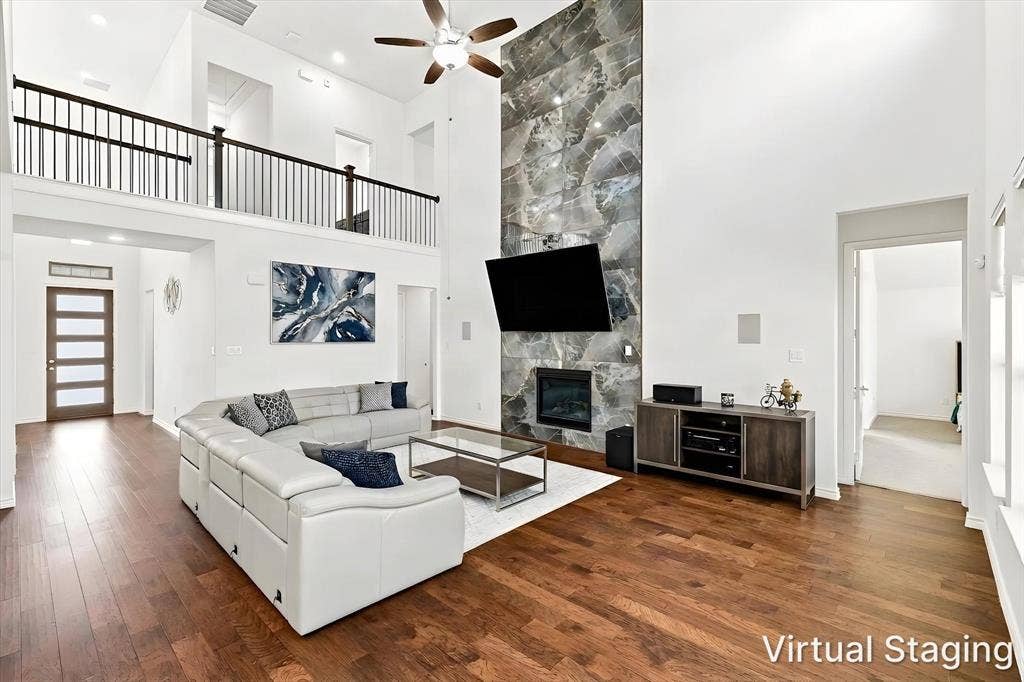 2812 Dunbar Drive, Northlake, TX 76247 Hardwood flooring and a two-story ceiling with a ceiling fan