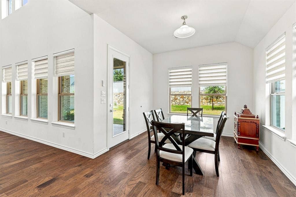 2812 Dunbar Drive, Northlake, TX 76247 High vaulted ceiling, wood-finish flooring, multiple windows with blinds, recessed lighting, and a glass-paneled door