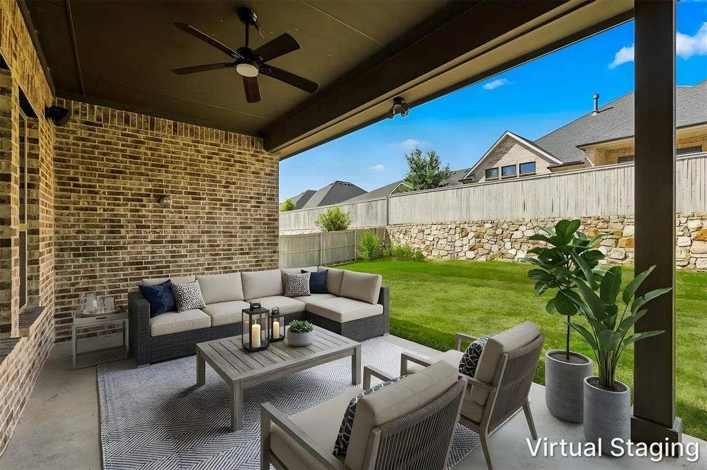 2812 Dunbar Drive, Northlake, TX 76247 Covered patio with a dark wood-finish ceiling fan, brick accent wall, and concrete flooring