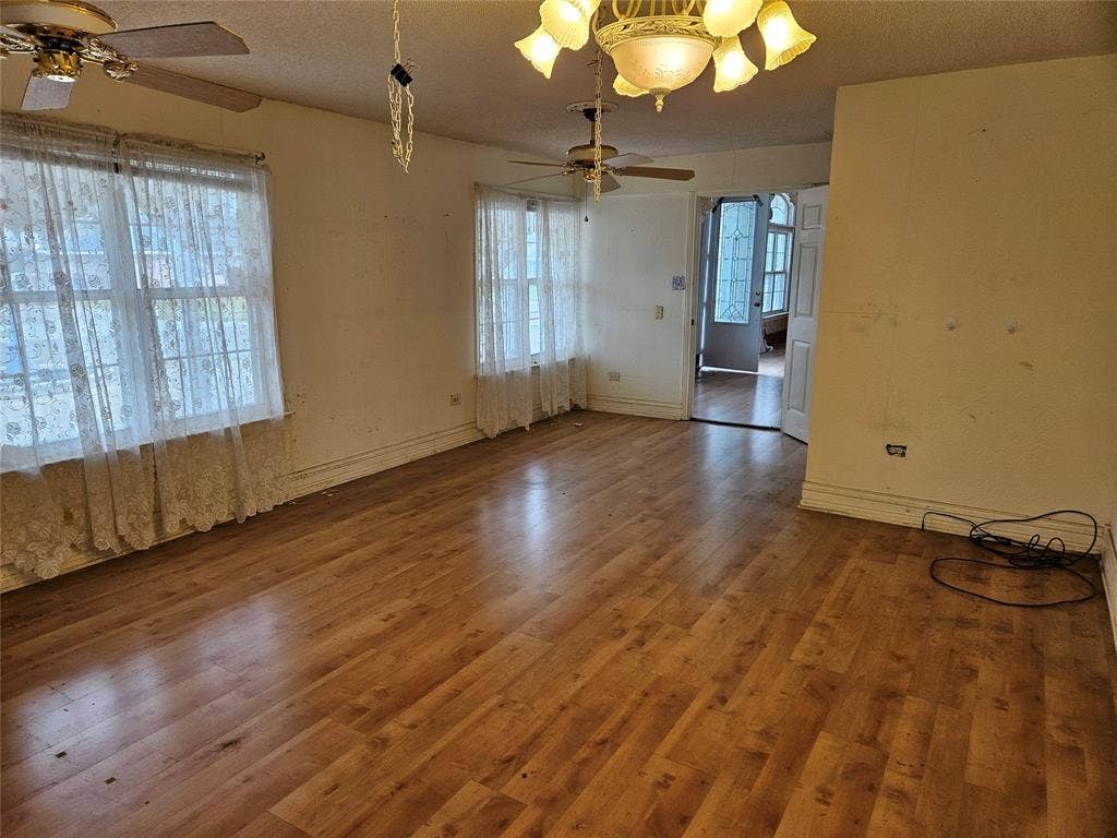 716 Dogwood Street, Robinson, TX 76706 Spare room featuring a ceiling fan, wood finished floors, a textured ceiling, and plenty of natural light