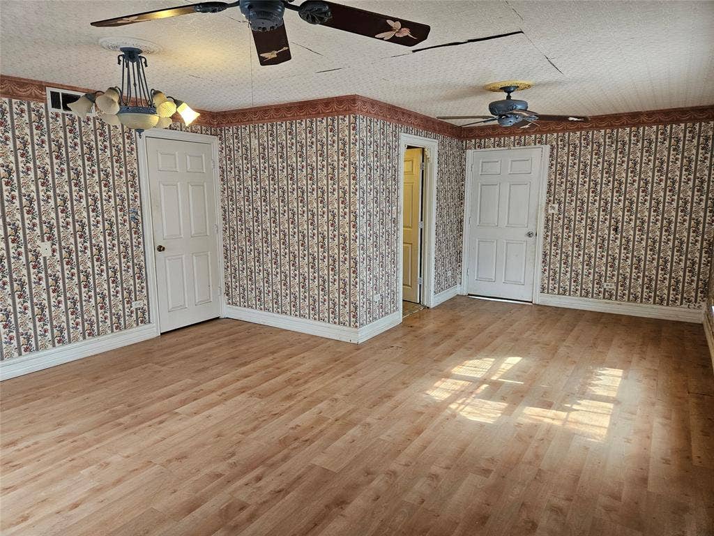 716 Dogwood Street, Robinson, TX 76706 Unfurnished room featuring ceiling fan, light wood-style flooring, and a textured ceiling
