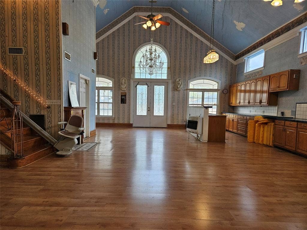716 Dogwood Street, Robinson, TX 76706 Living room featuring a high ceiling, wallpapered walls, dark wood-style floors, a ceiling fan, and heating unit