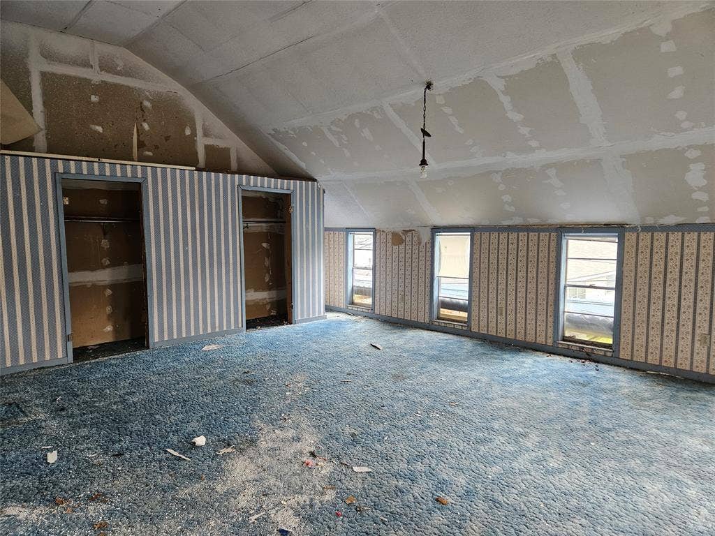 716 Dogwood Street, Robinson, TX 76706 Unfurnished living room with healthy amount of natural light and lofted ceiling