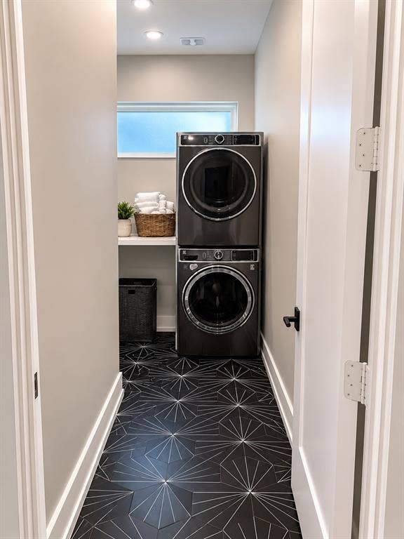 939 N Buckner Boulevard, Dallas, TX 75218 Laundry area featuring black patterned tile flooring, a built-in shelf, and a frosted window