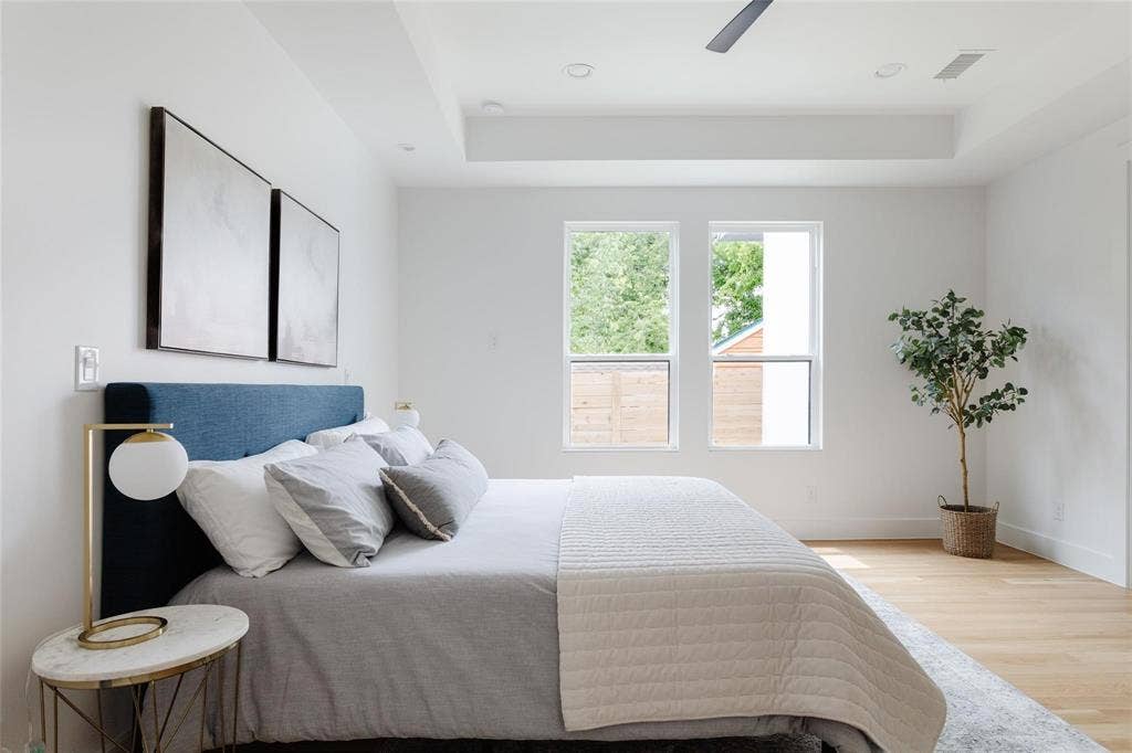 939 N Buckner Boulevard, Dallas, TX 75218 Recessed lighting, light wood-finish flooring, tray ceiling, two windows, and a ceiling fan