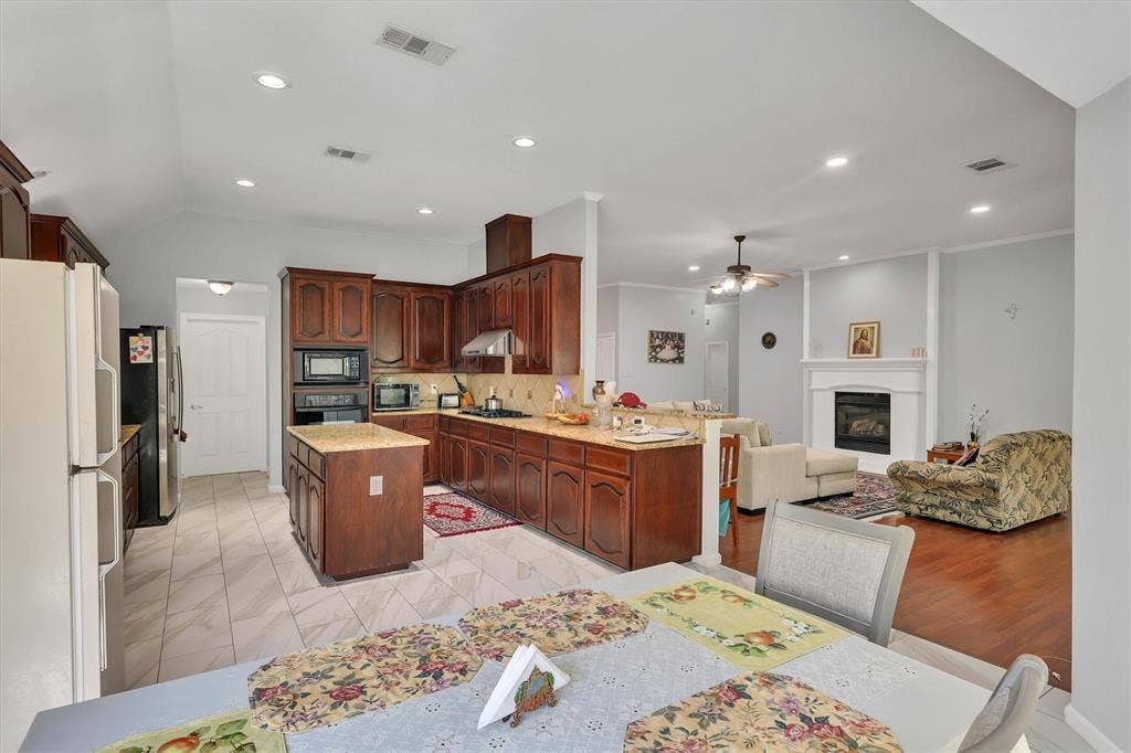 1506 Park Grove Drive, Irving, TX 75060 Kitchen with dark wood cabinetry, light-toned countertops, and tile flooring