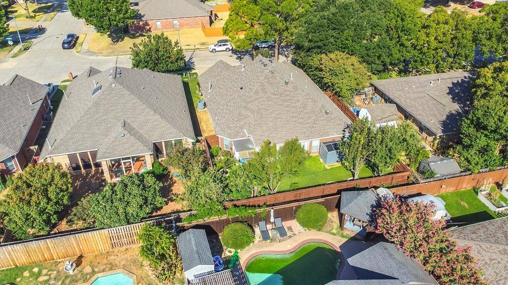 1506 Park Grove Drive, Irving, TX 75060 Expansive fenced backyard with mature trees, providing privacy