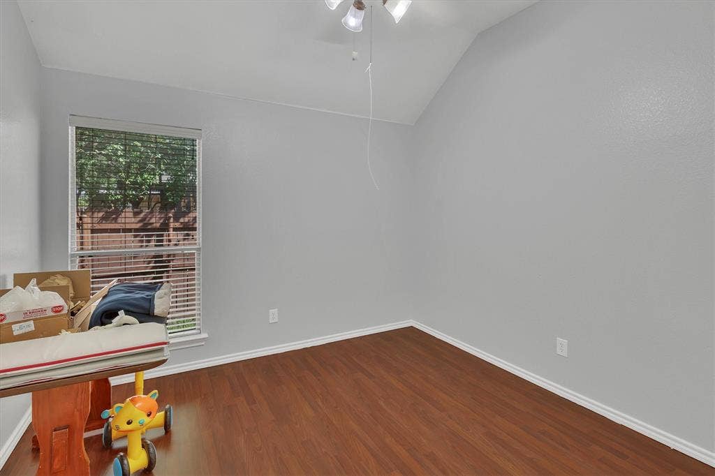 1506 Park Grove Drive, Irving, TX 75060 Vaulted ceiling with a ceiling fan, wood-finish flooring, and window with blinds