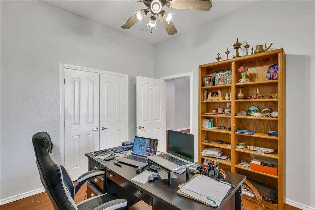 1506 Park Grove Drive, Irving, TX 75060 Wood-finish flooring throughout, ceiling fan with light fixture, and white wall paint