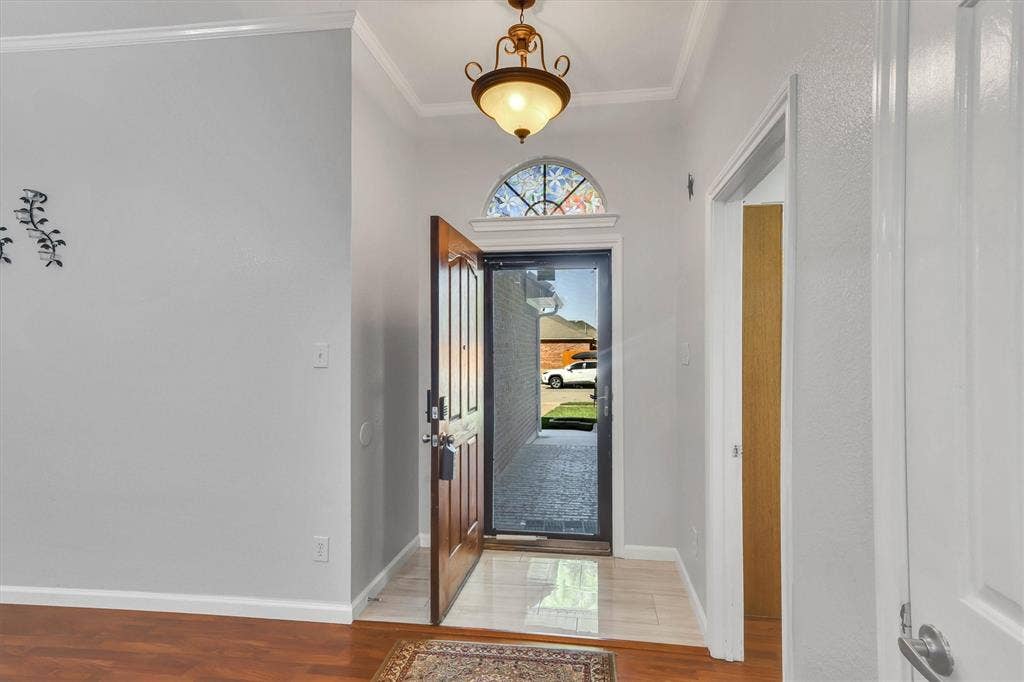 1506 Park Grove Drive, Irving, TX 75060 Entryway featuring wood-finish flooring and tile, a decorative transom window, and an ornate ceiling fixture