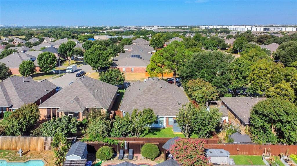 1506 Park Grove Drive, Irving, TX 75060 Residential neighborhood featuring mature trees, a private fenced yard, an in-ground pool, and a storage shed