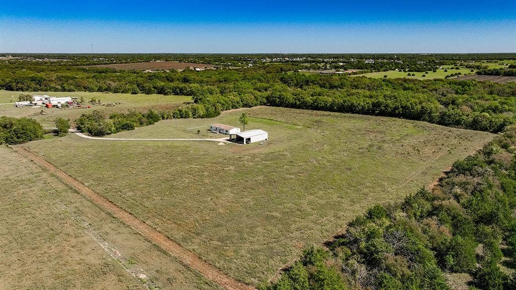 20132 County Road 818, Farmersville, TX 75442 Expansive grounds featuring a single-story dwelling, a detached carport, and perimeter tree lines