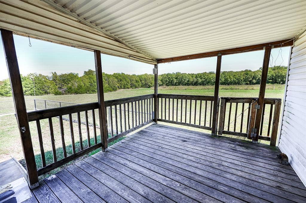 20132 County Road 818, Farmersville, TX 75442 Covered porch with wood flooring and railing