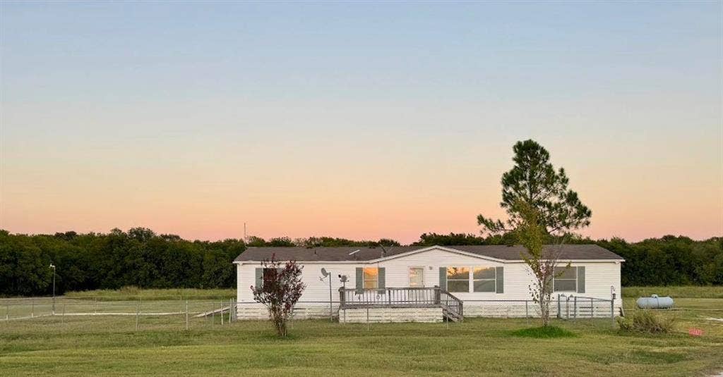 20132 County Road 818, Farmersville, TX 75442 White exterior with a front deck and mature trees