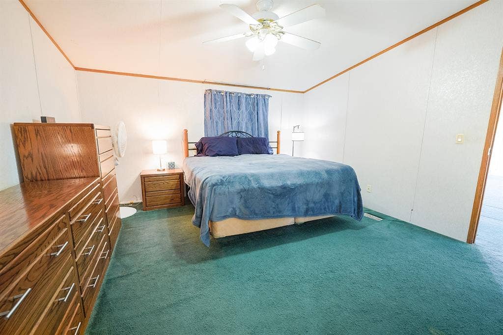 20132 County Road 818, Farmersville, TX 75442 Room featuring wall-to-wall carpeting, white paneling, and wood trim details