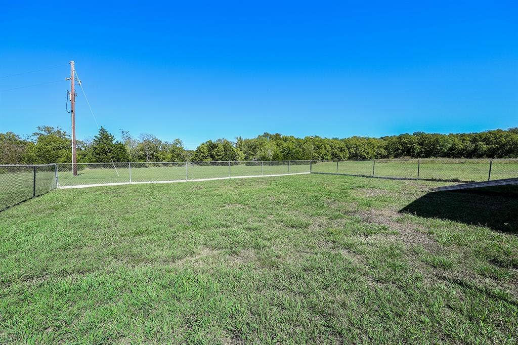 20132 County Road 818, Farmersville, TX 75442 Expansive grassy area with chain link fencing
