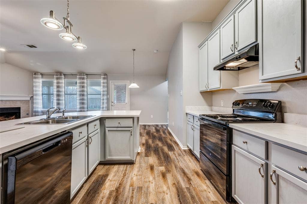 Eat-in kitchen with updated lighting.