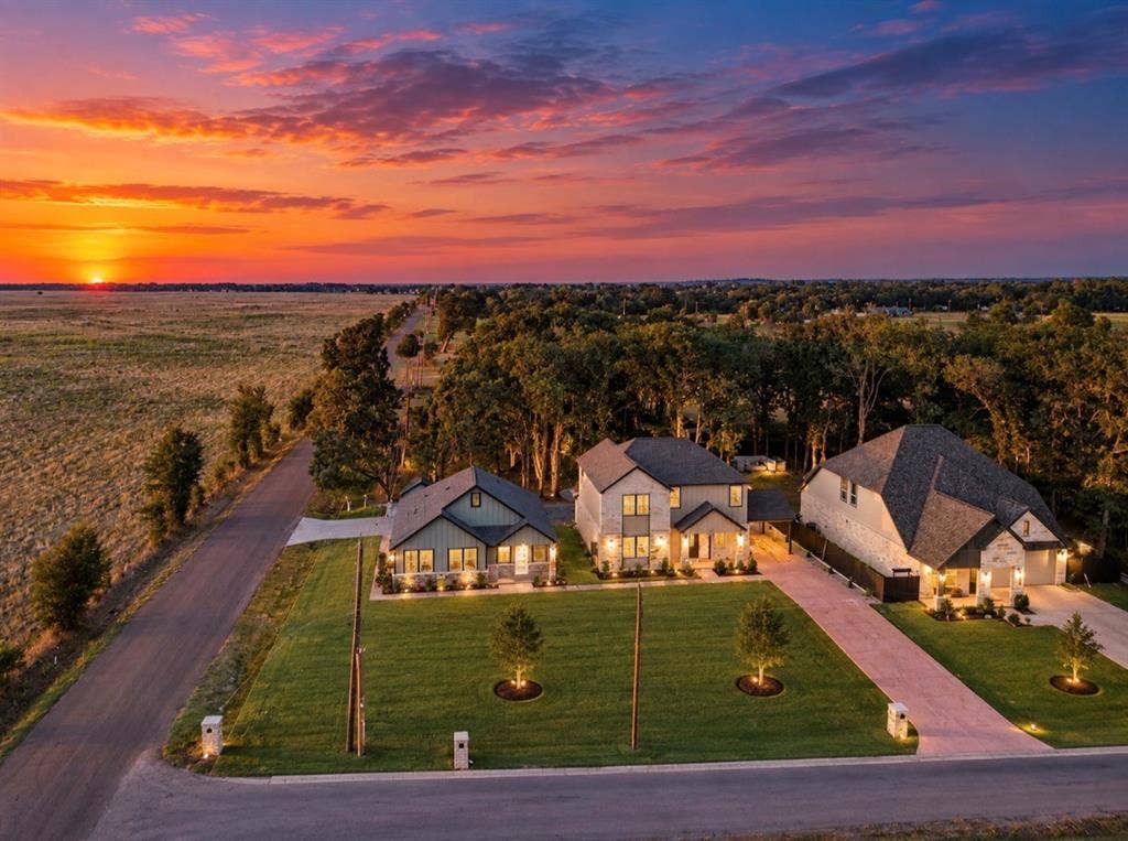 101 Water Oak Road, Trinidad, TX 75163 Aerial perspective showcasing multiple homes with varied architectural styles, expansive green lawns, and long driveways
