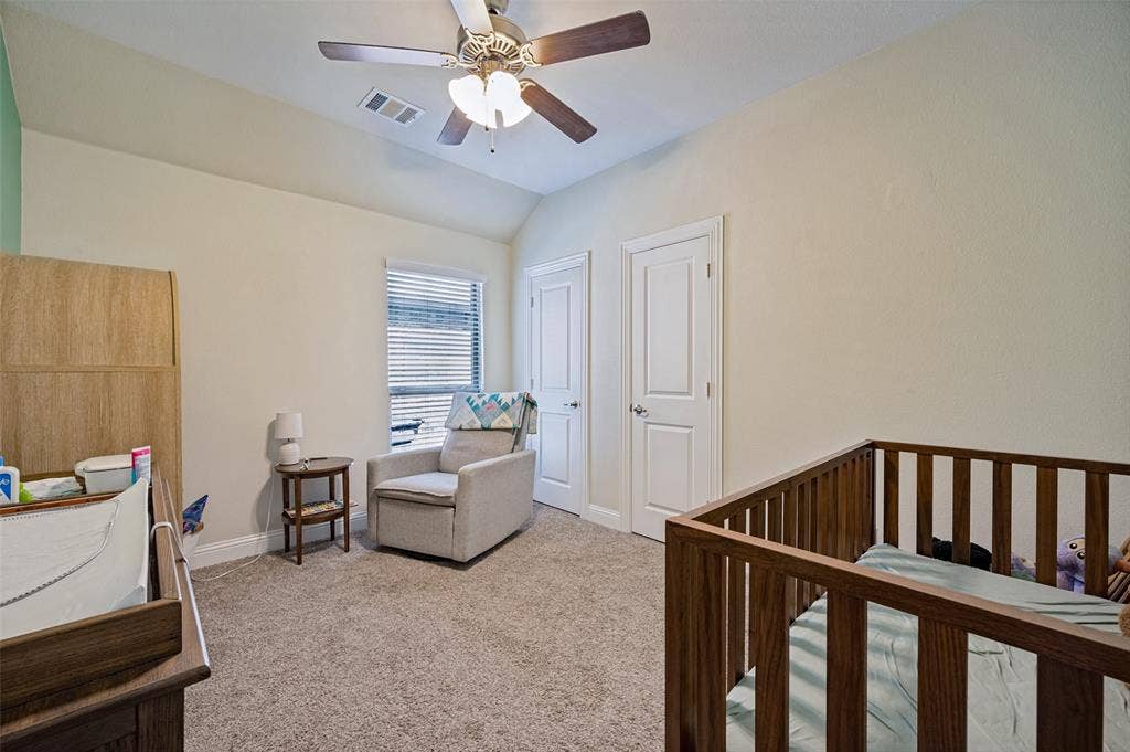1429 Green Valley Way, Celina, TX 75009 Vaulted ceiling with a ceiling fan, window with blinds, two paneled doors, and carpeted flooring