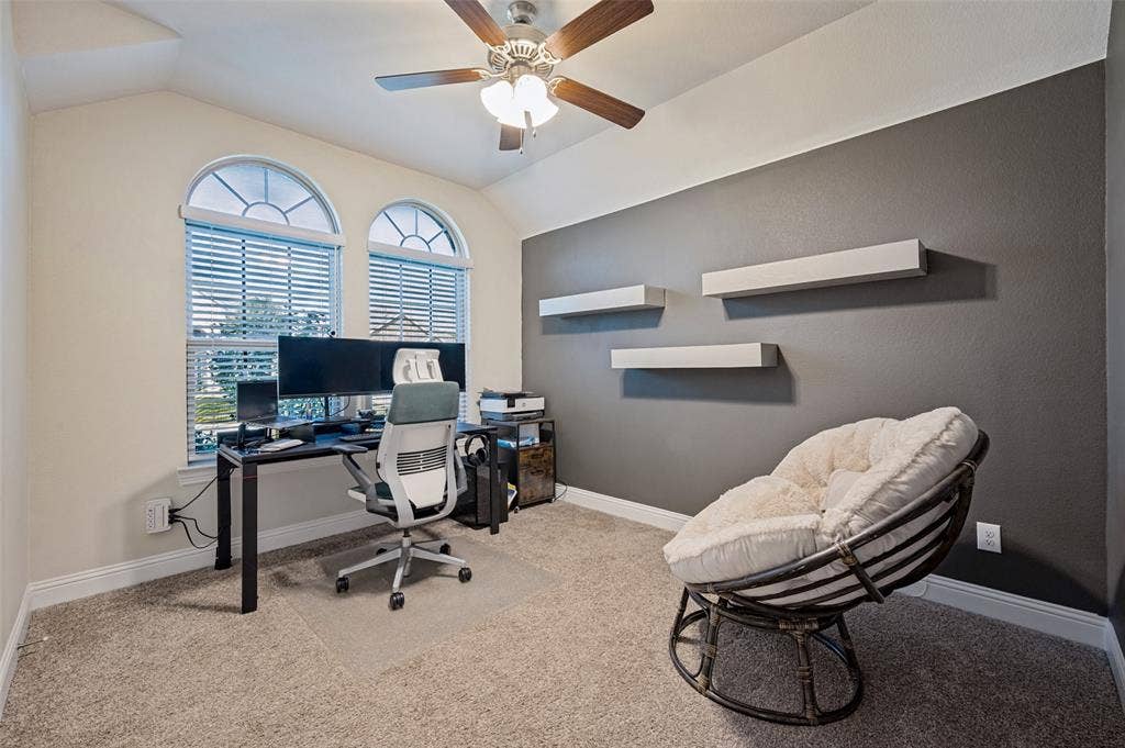 1429 Green Valley Way, Celina, TX 75009 Arched windows with blinds, ceiling fan, carpeted flooring, and wall-mounted shelving